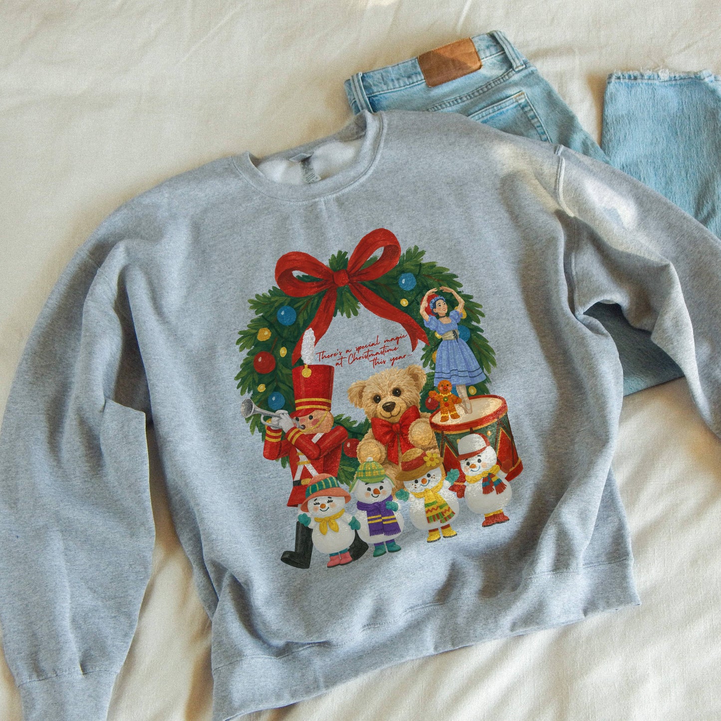Gray sweatshirt with Christmas design and jeans on a light background