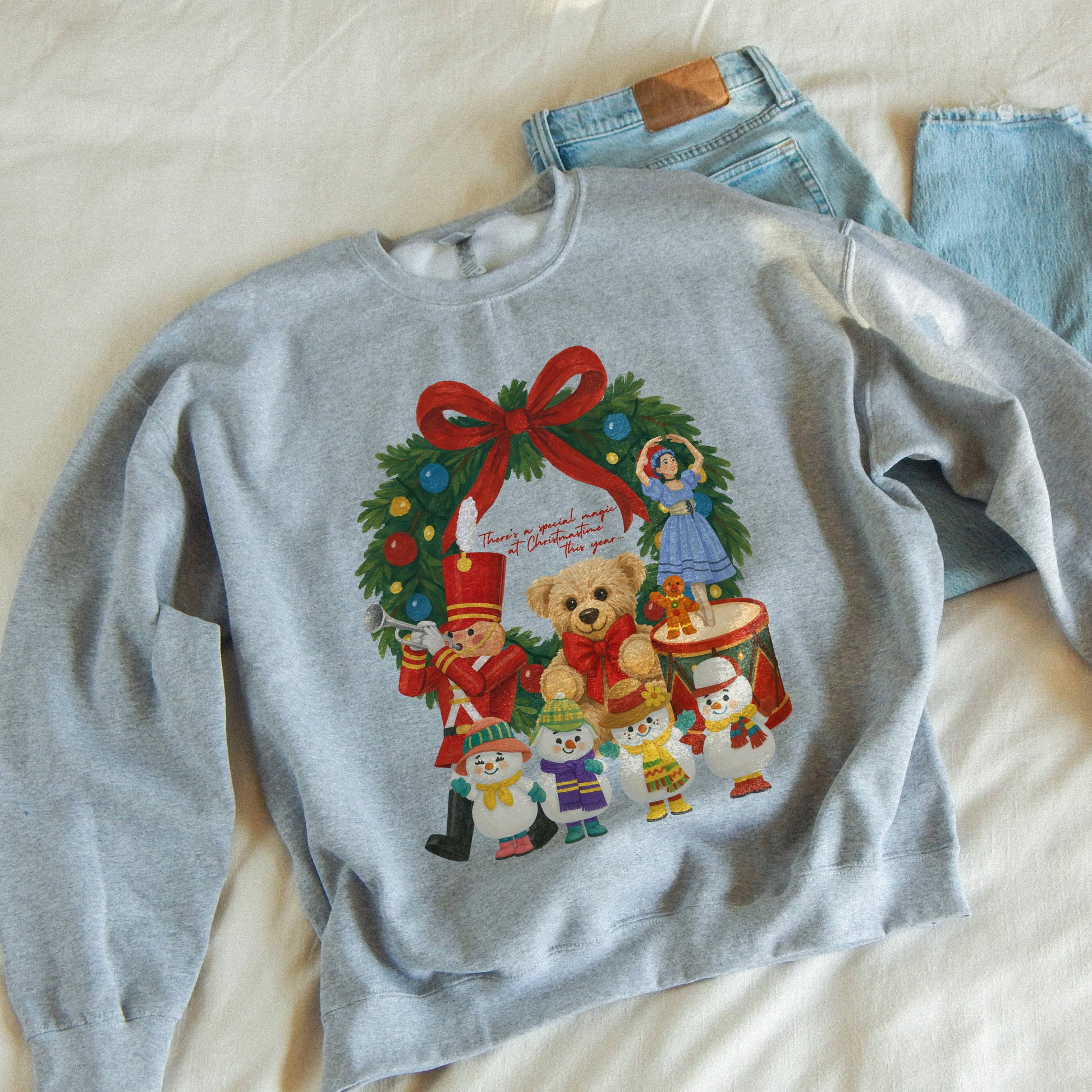 Gray sweatshirt with Christmas design and jeans on a light background